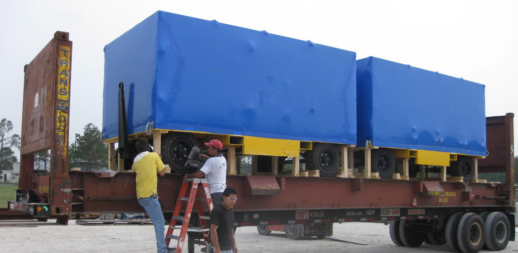 Crate of motor carts on the bed of an 18-wheeler