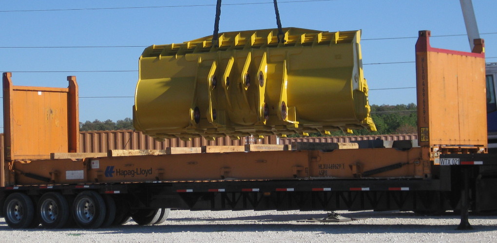 Large truck carrying an jumbo Excavator bucket